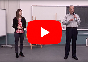 Youtube play icon on a candid from the workshop with Dr. John Bandler and Ana Kovacevic