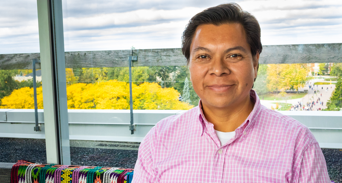 Portrait of graduate student Oscar Lopez Hernandez with the U of G campus in the background