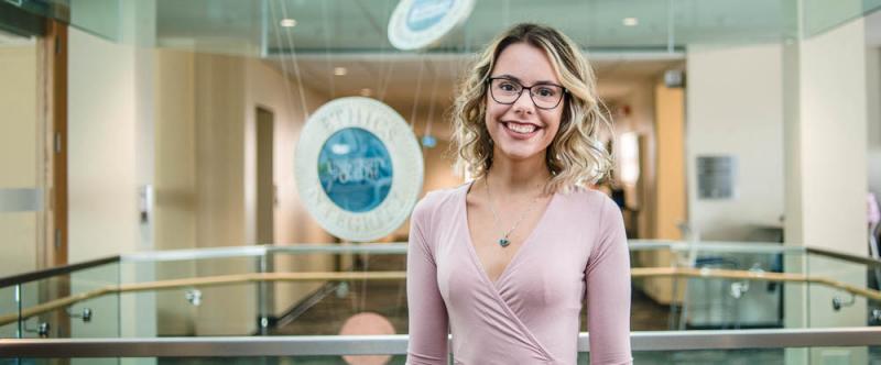 Portrait of graduate student Tracy Bento (MSc, Marketing & Consumer Studies) in the atrium of MacDonald Stewart Hall at the University of Guelph