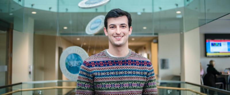 Portrait of graduate student Ethan Danielli (MSc, Human Health & Nutritional Sciences) in the atrium of Mac Donald Stewart Hall at the University of Guelph