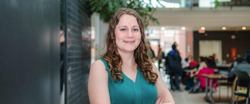 Portrait of graduate student Shannon French (PhD, Pathobiology) in the atrium of the Albert A. Thornbrough Building, University of Guelph