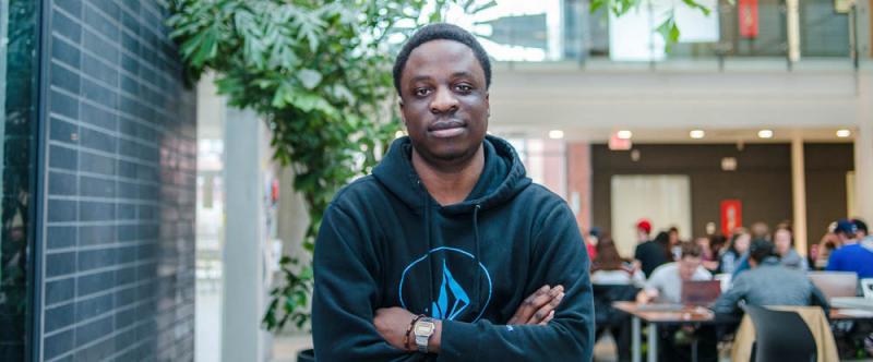 Portrait of graduate student Trust Katsande (MSc, Plant Agriculture) in the atrium of the Albert A. Thornbrough Building, University of Guelph