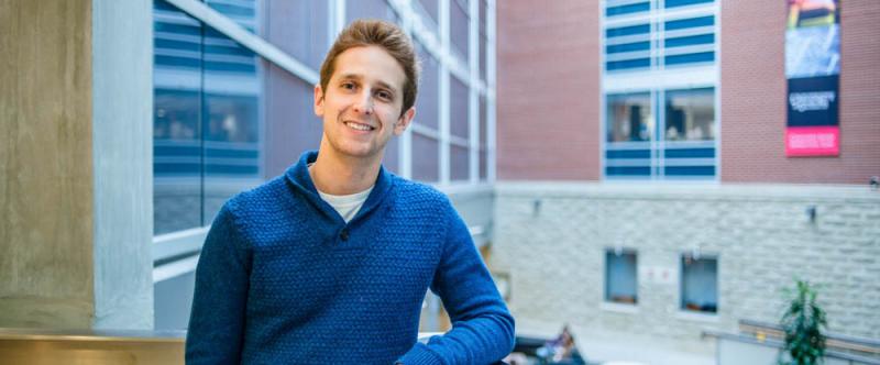 Portrait of graduate student Ari Mendell (PhD, Biomedical Sciences & Neuroscience) in the Science Atrium at the University of Guelph