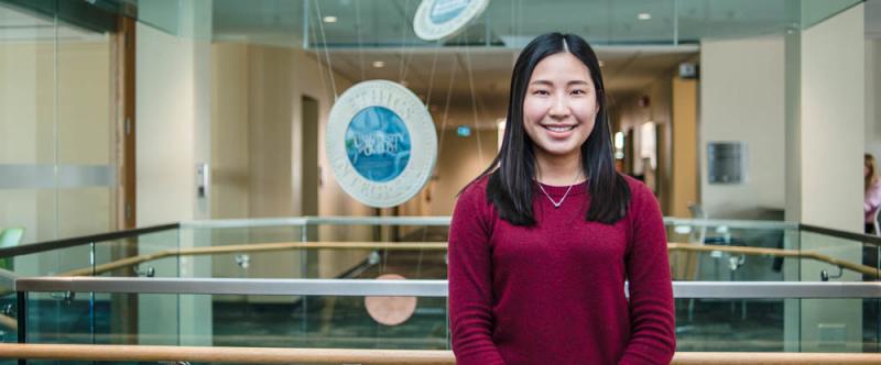 Portrait of graduate student Natalie Ng (MSc, Food Science) in the atrium of Mac Donald Stewart Hall at the University of Guelph