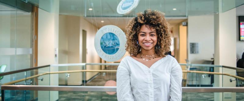 Portrait of graduate student Lilas Randrianarivony (MSc, Apacity Development & Extension) in the atrium of Mac Donald Stewart Hall at the University of Guelph