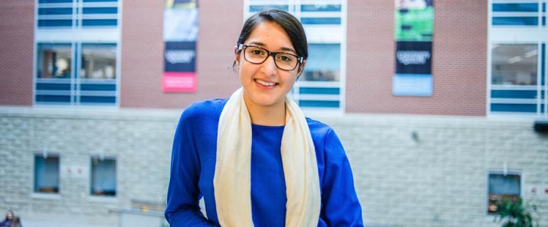 Portrait of graduate student Sidra Sarfaraz (MSc, Human Health & Nutrtional Sciences) in theScience Atrium at the University of Guelph