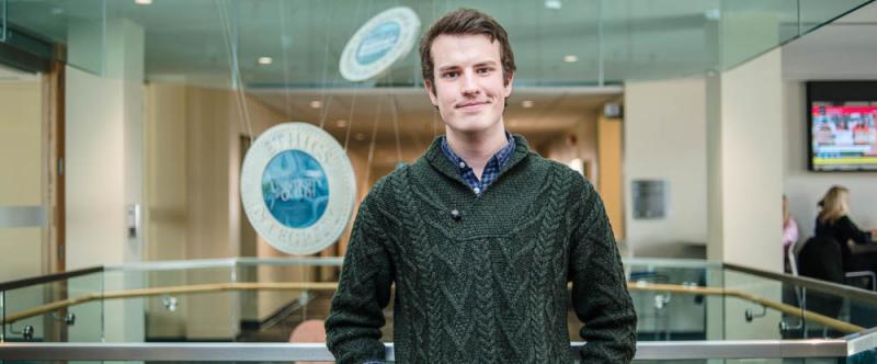 Portrait of graduate student Mason Stothart (MSc, Inttegrative Biology) in the atrium of Mac Donald Stewart Hall at the University of Guelph