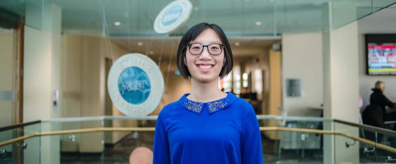 Portrait of graduate student Lydia Wang (MSc, Food Science) in the atrium of Mac Donald Stewart Hall at the University of Guelph