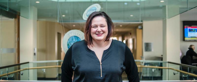 Portrait of graduate student Ashleigh Weeden (PhD, Rural Studies) in the atrium of Mac Donald Stewart Hall at the University of Guelph