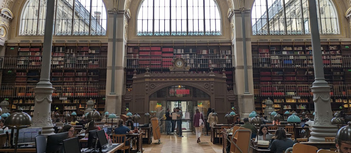 Image of a library in France which links to the brochure for Integrated Humanities MA at U of G
