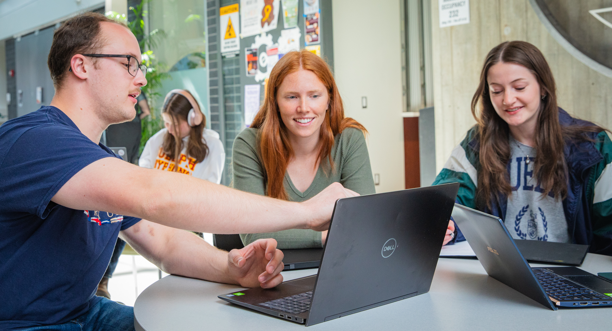 3 U of Guelph Engineering students working at a table