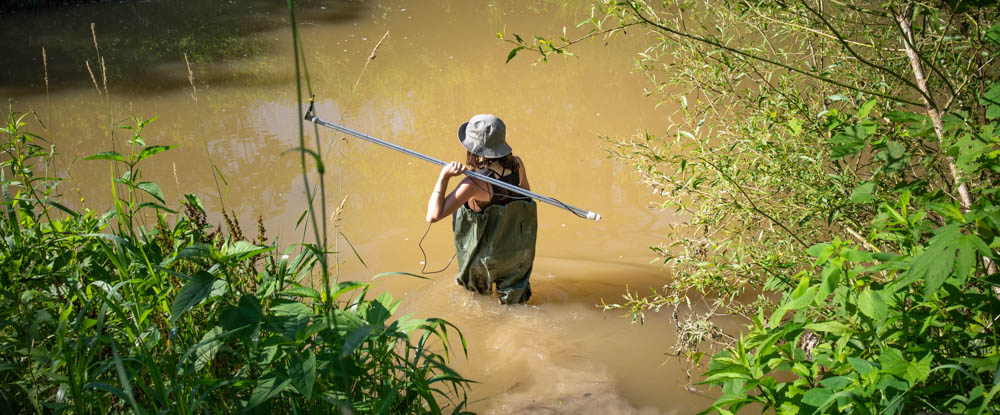 U of Guelph Engineering grad student Hannah May in a river