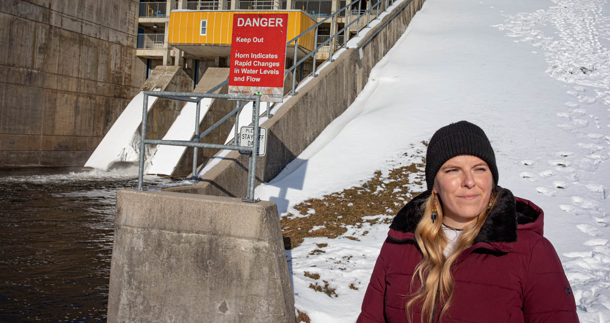 U of Guelph Rural Planning and Development MSc candidate Jessica Wakefield in front of the Guelph Lake Dam