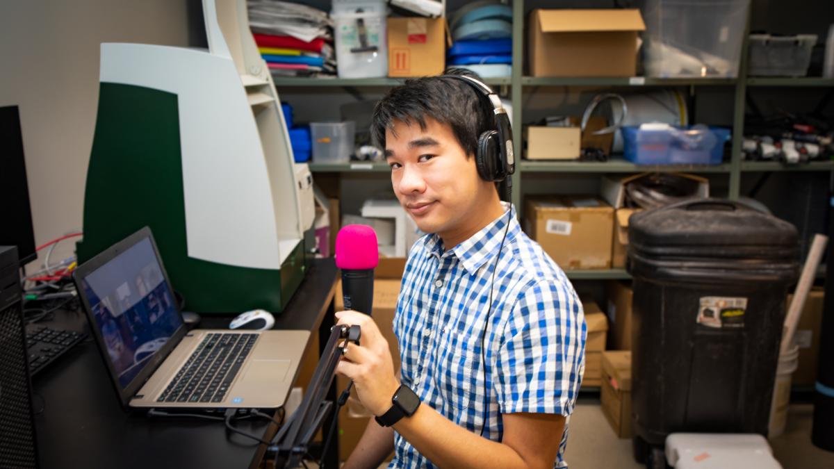 Michael Lim doing his podcast in a supply room in the Summerlee Science Complex