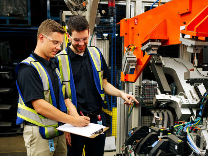 two people in a robotics shop