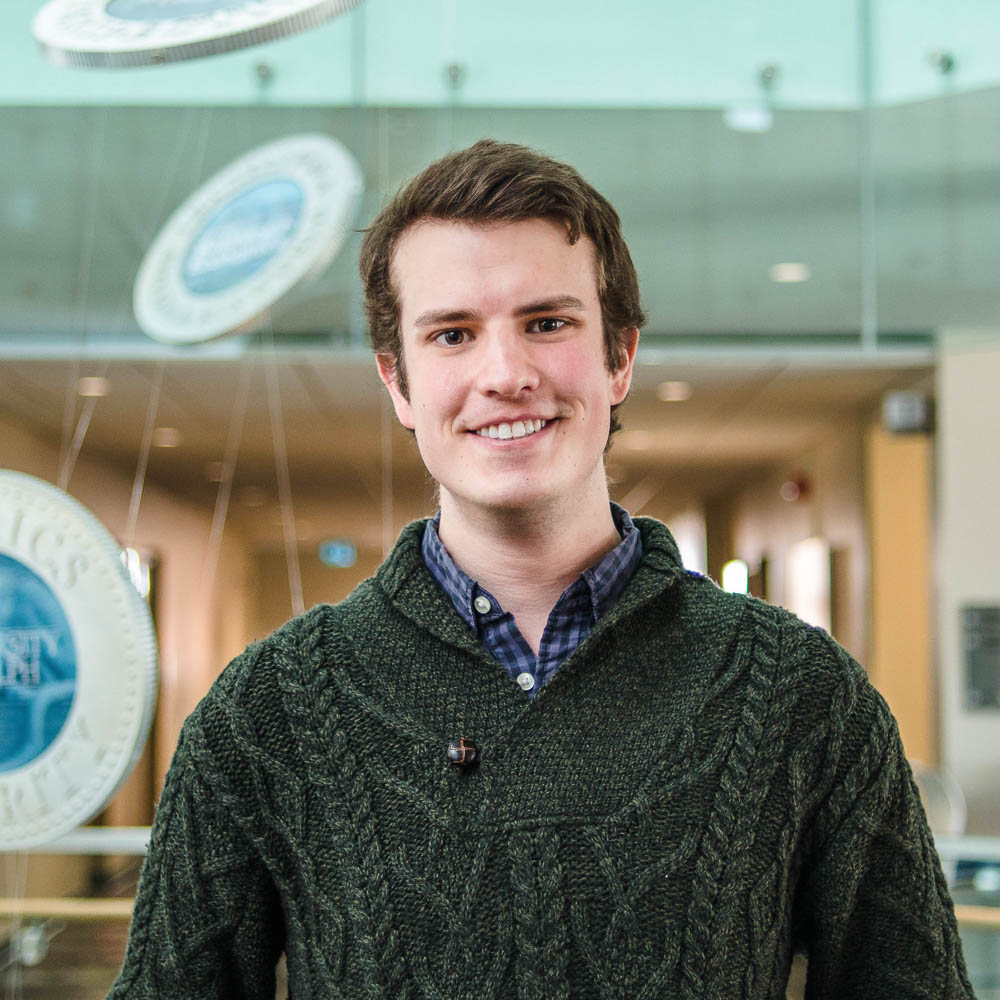 Portrait of graduate student Mason Stothart (MSc, Inttegrative Biology) in the atrium of Mac Donald Stewart Hall at the University of Guelph