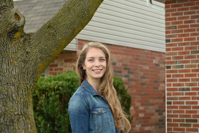 Photo of UofG Graduate Student Elizabeth Porter standing against a tree