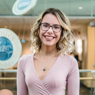 Portrait of graduate student Tracy Bento (MSc, Marketing & Consumer Studies) in the atrium of MacDonald Stewart Hall at the University of Guelph