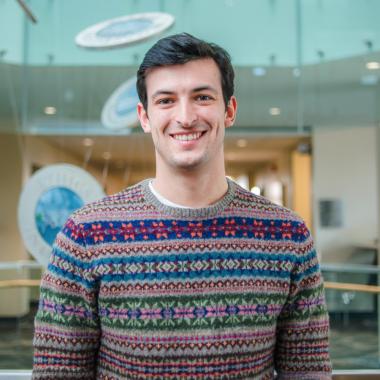 Portrait of graduate student Ethan Danielli (MSc, Human Health & Nutritional Sciences) in the atrium of Mac Donald Stewart Hall at the University of Guelph