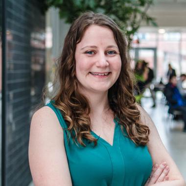 Portrait of graduate student Shannon French (PhD, Pathobiology) in the atrium of the Albert A. Thornbrough Building, University of Guelph